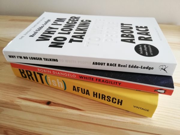 A stack of books used used by the Staff Action Research Group to inform understandings of racial politics. Books include "why I'm no longer talking to white people about race", "white fragility" and "BRIT-ish)".